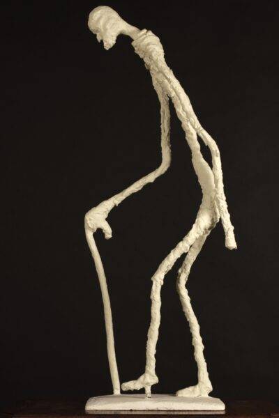 Irish sculpture of an elongated old man walking by Valeriu Cazacevschi