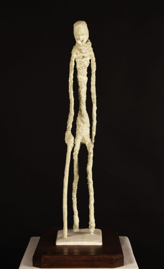 a surreal sculpture of a man with a cane ccreated by Valeriu Cazacevschi